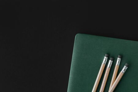 green note book and pen minimal styles tropical green palm leaves on bright background Minimal surrealism black background.の写真素材