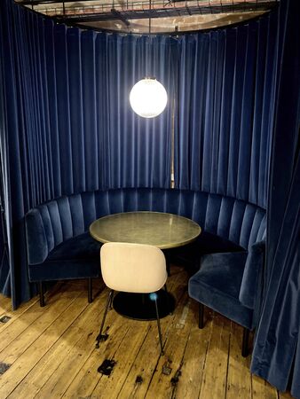 modern interior co working space design with blue sofa,brown table,dark blue background.Contemporary co working workplace and corporate concept.の写真素材