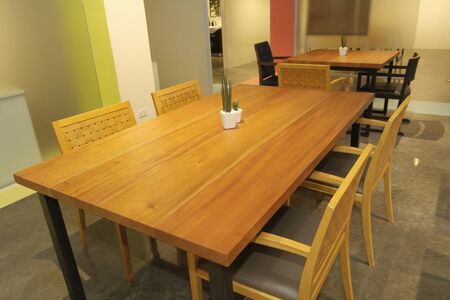 area modern co working space with brown chair,wood table,green leaf bright modern working space with...