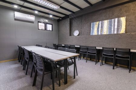 co working space modern style room with black chair,white table stylish room with soft lamp on backgroundの写真素材