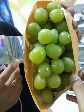 healthy fresh green grape fruit,composition with assorted raw organic in basket on nature backgroundの写真素材