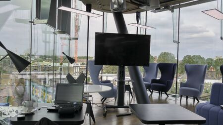 modern interior co working space design with white chair, screen, background.Contemporary co working workplace and corporate concept.の写真素材