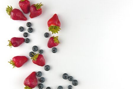 red fruit and blueberry fresh fruit in row isolated assortment clipping pat on black background