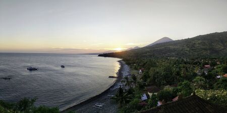 orange light beautiful sunset view sky above blue clouds with dramatic light on paradise tropical ocean islandの写真素材