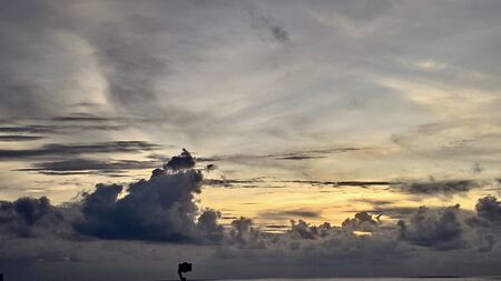 dark orange beautiful sunset view sky blue clouds with dramatic light on paradise tropical sea islandの写真素材