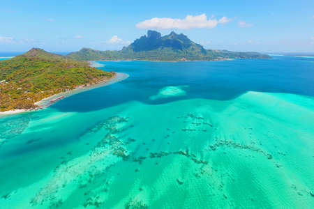 beautiful tropical paradise beach with white sand and coco palms on green sea panorama background.の写真素材