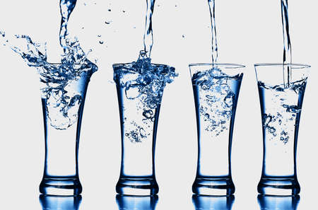 blue water transparent bottle glass splash abstract with bubbles on white background.の写真素材