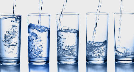 blue water transparent bottle glass splash abstract with bubbles on white background.