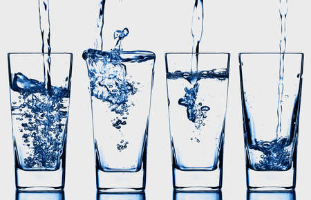 blue water transparent bottle glass splash abstract with bubbles on white background.の写真素材