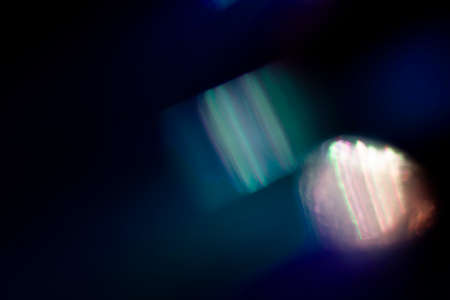 abstract dark blue and green neon glowing futuristic light with glow in the dark pattern on dark background.の写真素材