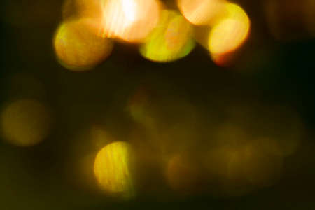 abstract light yellow neon glowing futuristic light with glow in the dark pattern on dark background.の写真素材