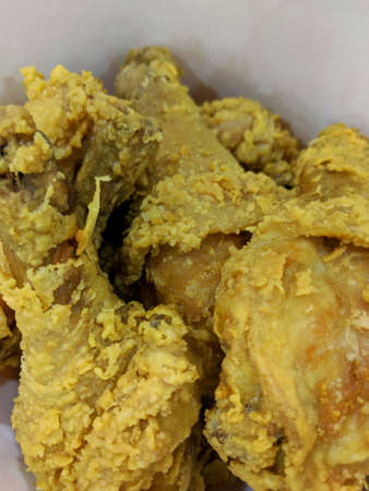 Fresh delicious crispy fried chicken golden brown on white box background.