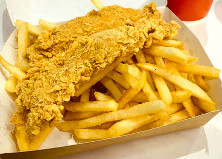 Fresh delicious crispy fried chicken golden brown on white box background.