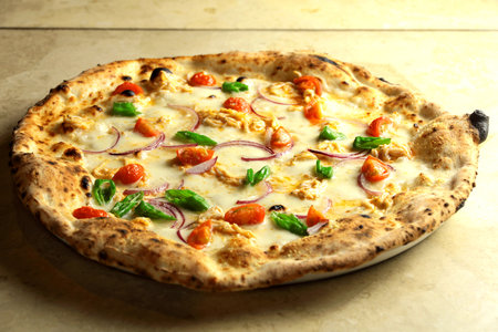 pizza tasty hot pepperoni covered slices cooking ingredients tomatoes with prosciutto and spices on background.の写真素材