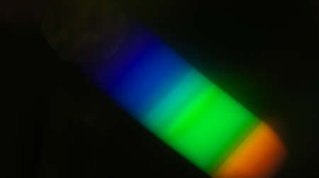 rainbow light overlay refraction texture diagonal natural holographic on black background.