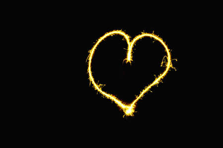 abstract heart gold sparkler overlays texture elegant surface pattern on black background.の写真素材