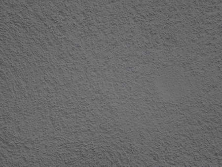 abstract dark gray plaster wall grunge natural retro texture with cement natural brick wall pattern on dark gray background.の写真素材