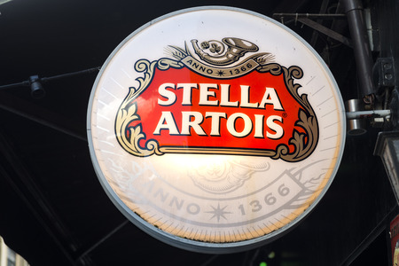 neonlit signpost with the logo of Belgian Stella Artois beer on black backgroundのeditorial素材