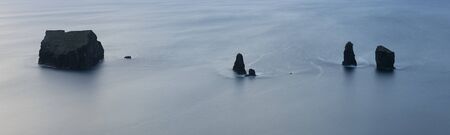 Evening artistic aerial nocturnal panorama of the Ilheu dos Mosteiros as seen from Miradouro do Caminho Velho on the Azores island of Sao Miguel, Portugalの写真素材