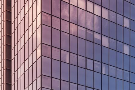 Afternoon lights reflected on the glass facade of an office buildingの写真素材