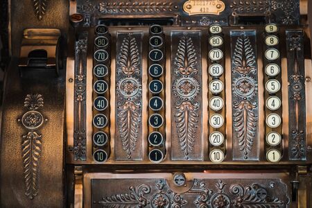 Frontal close-up of an antique cash register