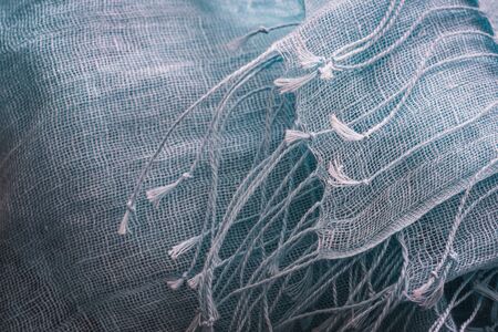 Decorative fringes of a blue cotton shawl