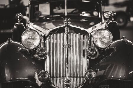 Front details of the grille and headlamps of a cabriolet sports car in black and whiteの写真素材