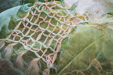 Macrame knots decorating a green crumpled shawlの写真素材