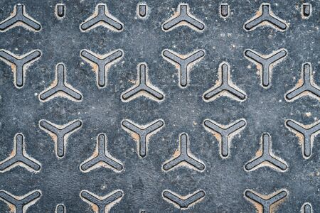 Geometric pattern of a metal manhole coverの写真素材