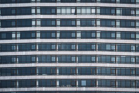 Rows of windows of an urban building creating a patternの写真素材