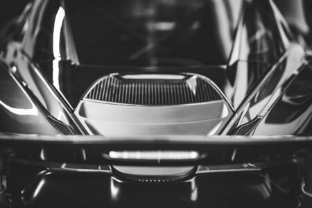 Back view of the spoiler and trunk of a sports car in black and whiteの写真素材