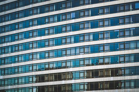 Rows of glazed windows of an urban buildingの写真素材