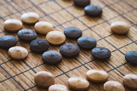 Wooden mixed chips over a board of the traditional chinese game called GOの写真素材