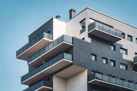 Geometric facades of a residential building full of balconies and windows