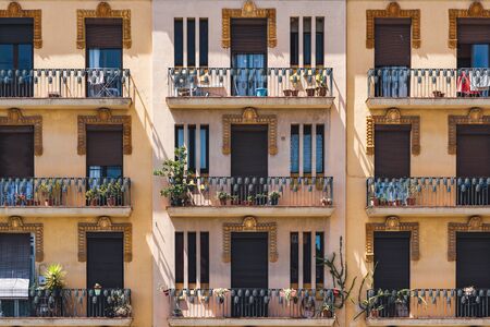 Colored facades and ornamental balconies of a neoclassical buildingの写真素材
