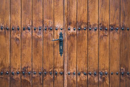 Traditional wooden door decorated with iron studsの写真素材