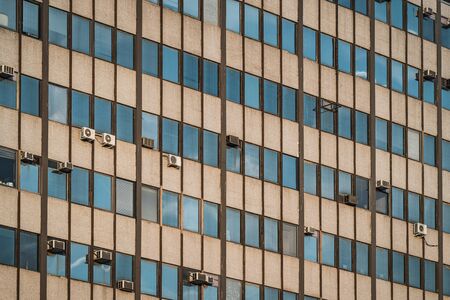External air conditioning units hanging on the facade of an old 1964s buildingの写真素材