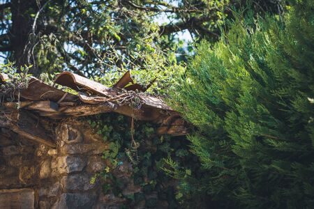 Corner of an old traditional mediterranean hut made of natural stones and terracotta handmade tilesの写真素材