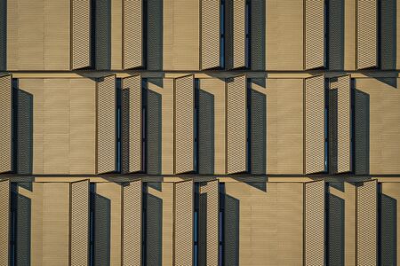 Modern building facade full of window shuttersの写真素材