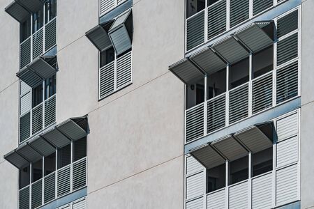 Metallic folding shutters of the facade of a modern residential buildingの写真素材