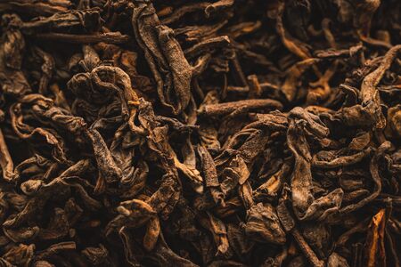 Macro background of dried leaves of aromatic black tea with cinnamonの写真素材