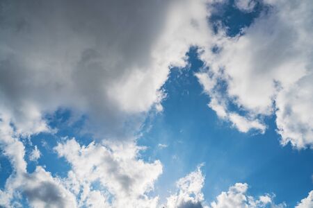 Growing cumulus clouds in a blue sky on a sunny dayの写真素材