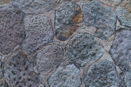 Texture of an old natural stone wallの写真素材