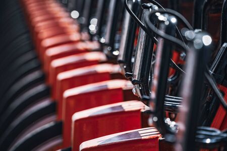 Abstract detail of a row of modern rental bicycles parked on a city streetの写真素材