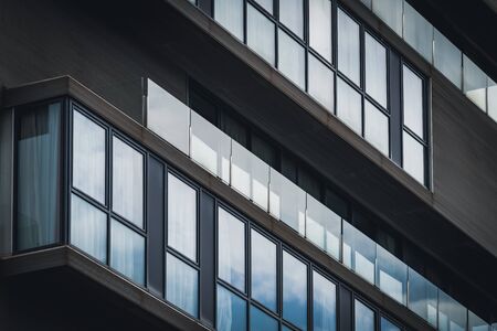 Architecture detail of the glass balconies of a minimalist urban buildingの写真素材