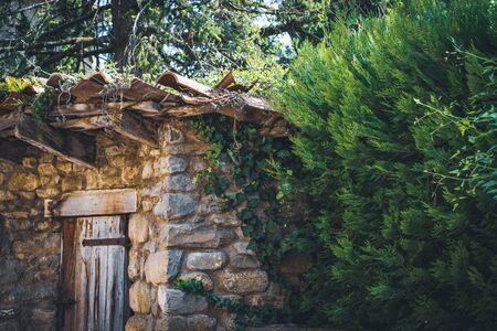 Corner of an old traditional mediterranean hut made of natural stones and terracotta handmade tilesの写真素材
