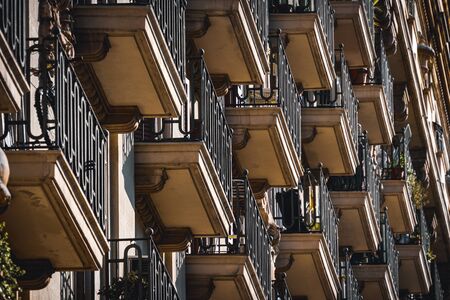 Low angle view of rows of neoclassical balconies on the facade of a residential buildingの写真素材