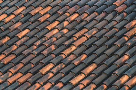 Background of traditional mediterranean terracotta roof tiles forming a diagonal patternの写真素材