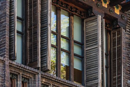 Detail of the upper windows with wooden shutters of Golferichs House in Barcelonaの写真素材