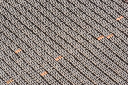 Background of traditional terracotta tiles of an old roof forming a diagonal patternの写真素材